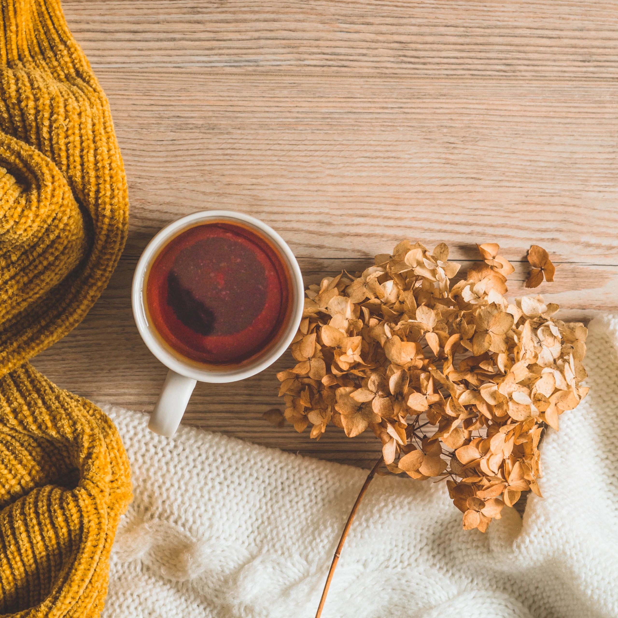 Cozy tea and candle still life for seasonal reading mood