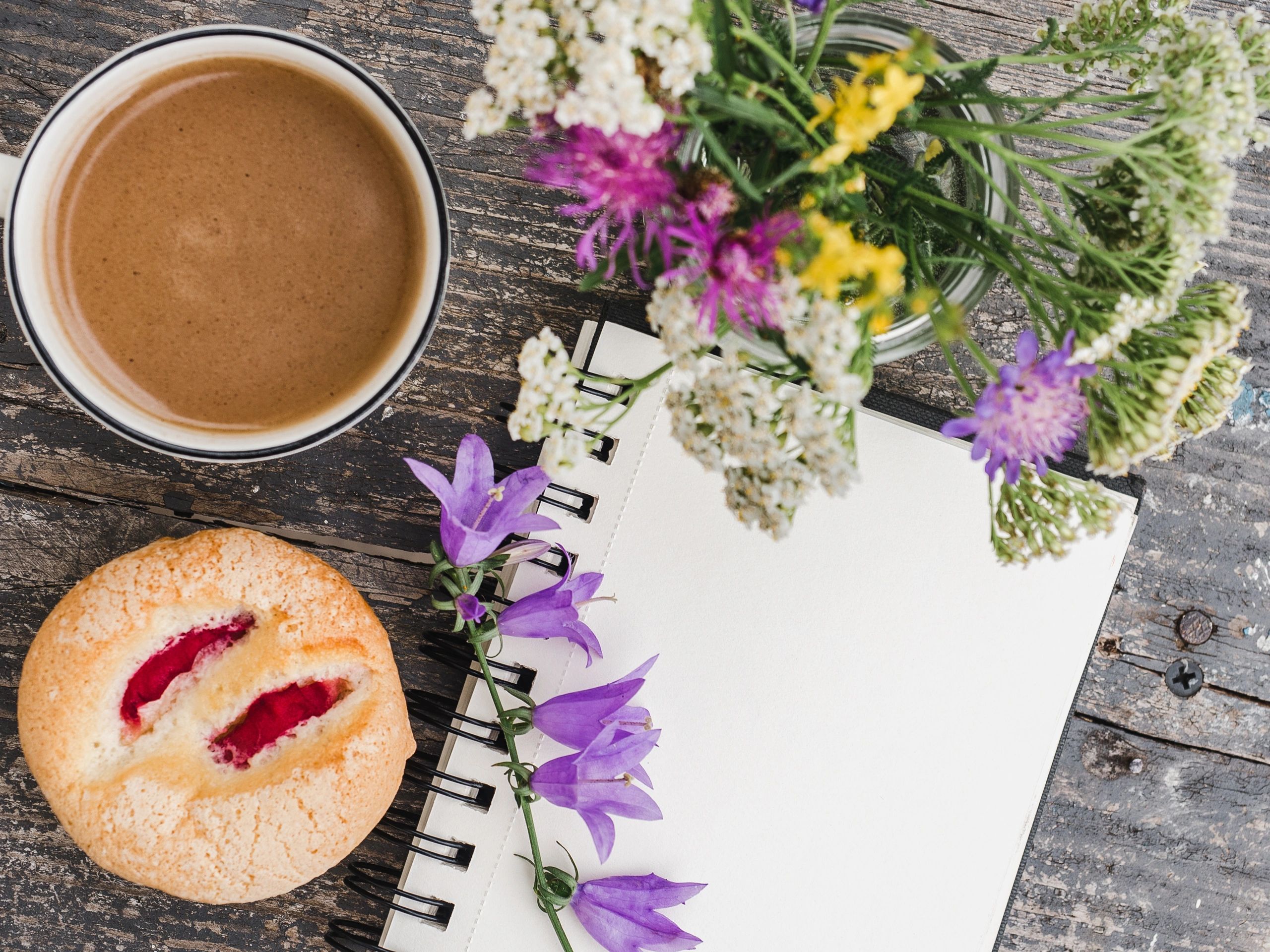 Cup of hot coffee with flowers on a cozy table