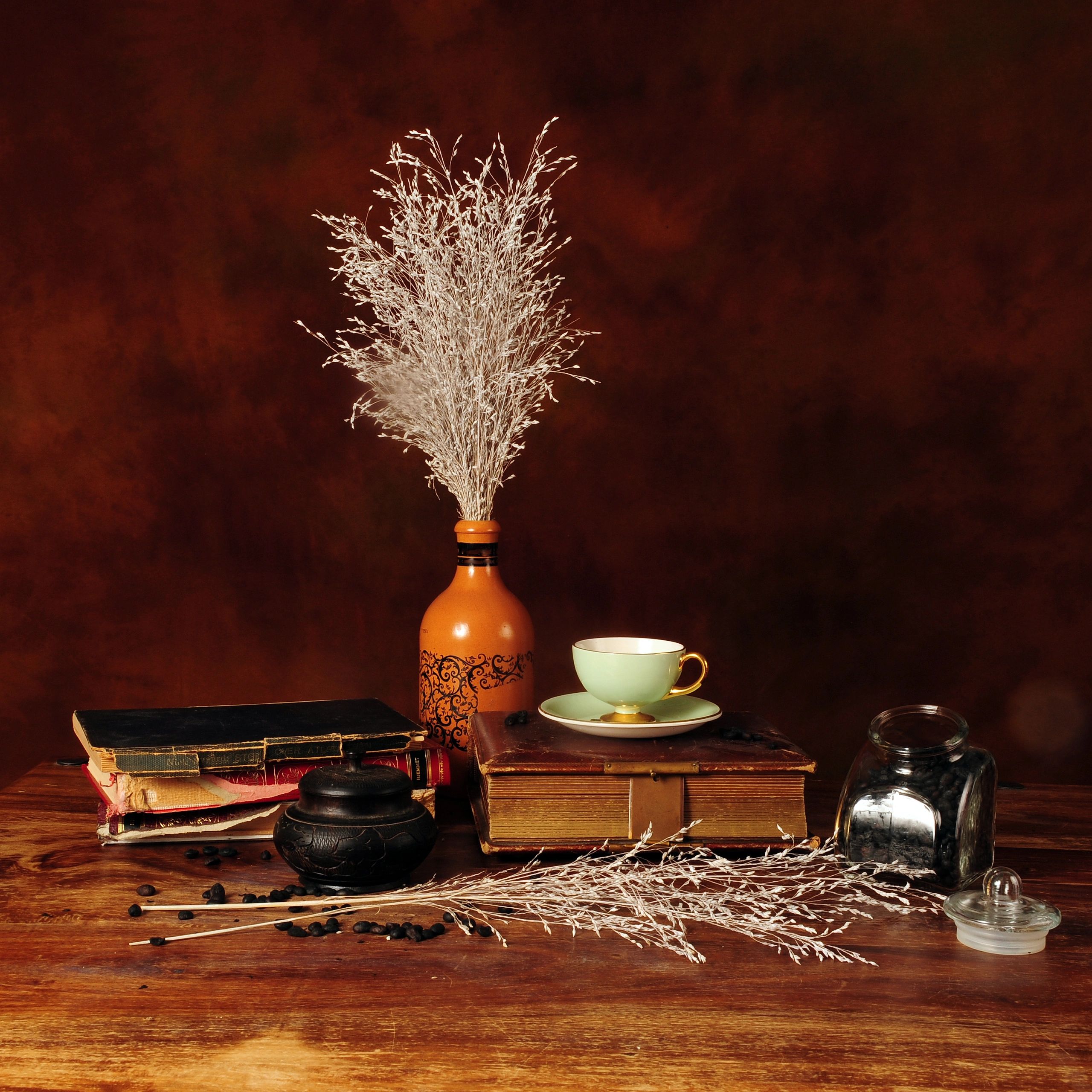 Coffee and old books arranged on a table