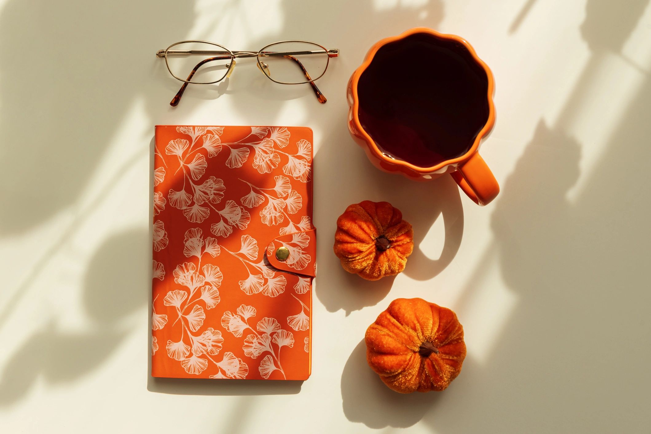 Warm seasonal flat lay with coffee and autumn decor